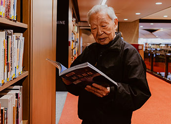 Photo of a man reading a book. Photo of a man reading a book.