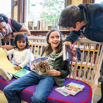 Kids and adults with books. Links to Beneficiary Designations