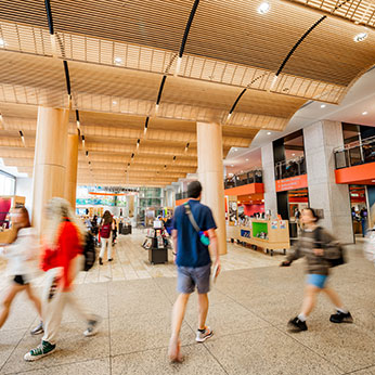 People walking outside the library. Links to Gifts by Will