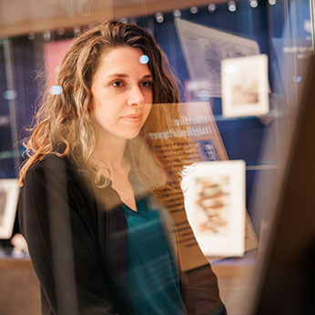 A woman looking at a display. Links to Donor-Advised Funds
