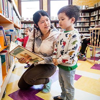 A mother showing her child a book. Links to Closely Held Business Stock