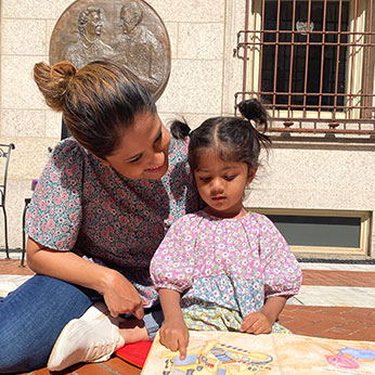 Mother and child reading a book. Links to What to Give