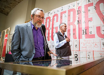 Photo of a man looking at a display. Photo of a man looking at a display.